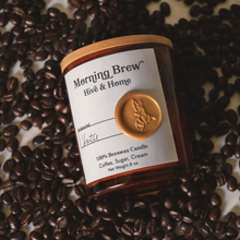 Load image into Gallery viewer, Flat lay of our apothecary beeswax candle against a plethora of fresh coffee beans