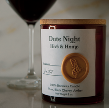 Load image into Gallery viewer, Our apothecary beeswax candle sits in front of a glass of pinot noir contrasted against a golden Carrera marble background.