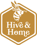 Hive & Home logo of their name in the middle of a gold hexagon and a side-view of a worker bee above it. It's encompassed by border of another hexagon.