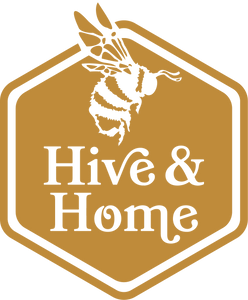 Hive & Home logo of their name in the middle of a gold hexagon and a side-view of a worker bee above it. It's encompassed by border of another hexagon.